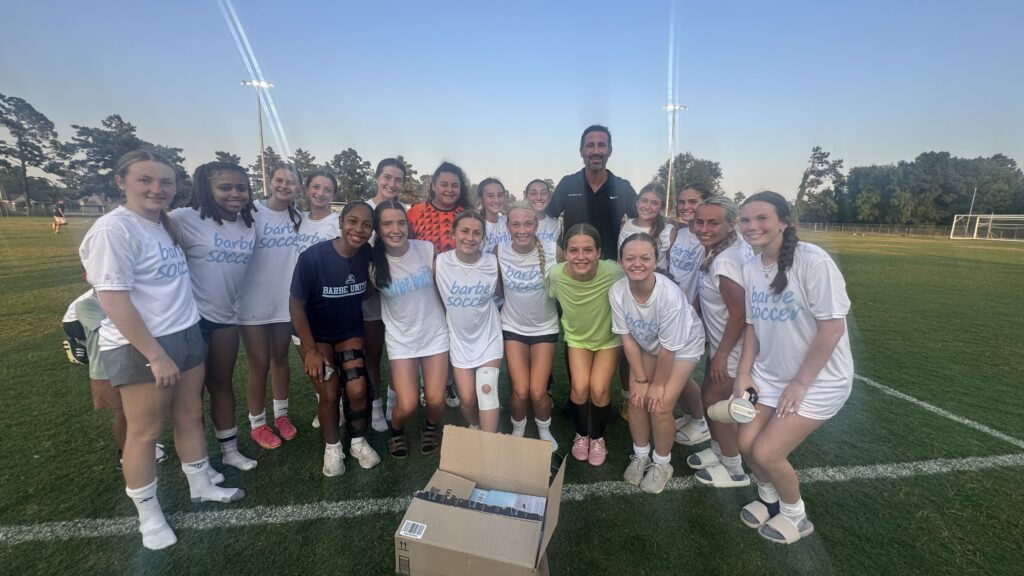 Soccer team poses with Ramez on the field