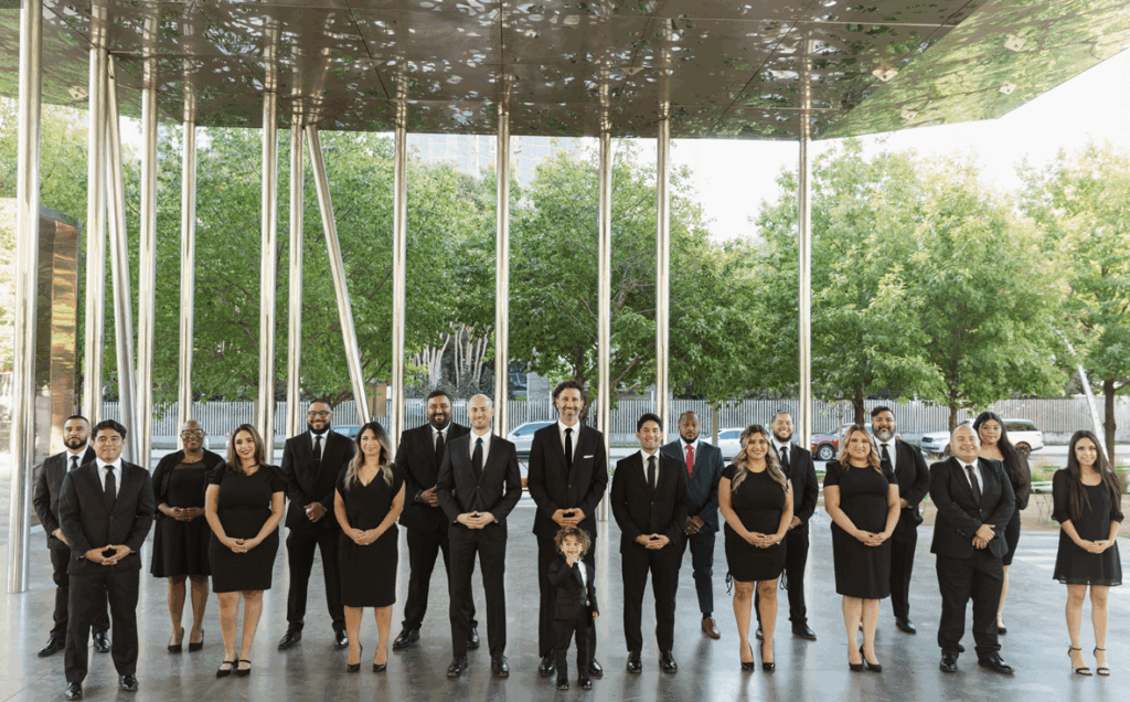 Team photo of Shamieh Law, including the director of Family Law- Ramez Shamieh's toddler son with a lollipop in front