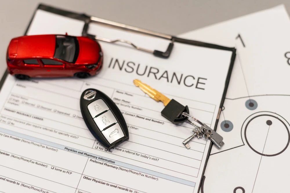 car insurance stock photo with car keys, document, and toy car