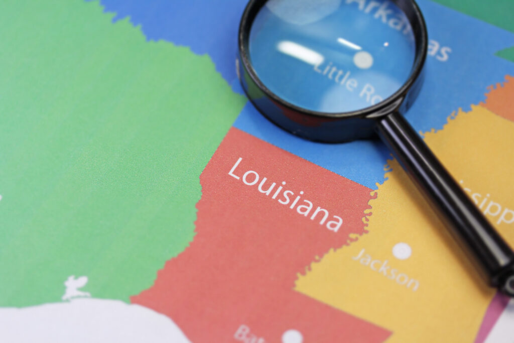 Magnifying glass focusing on map of louisiana
