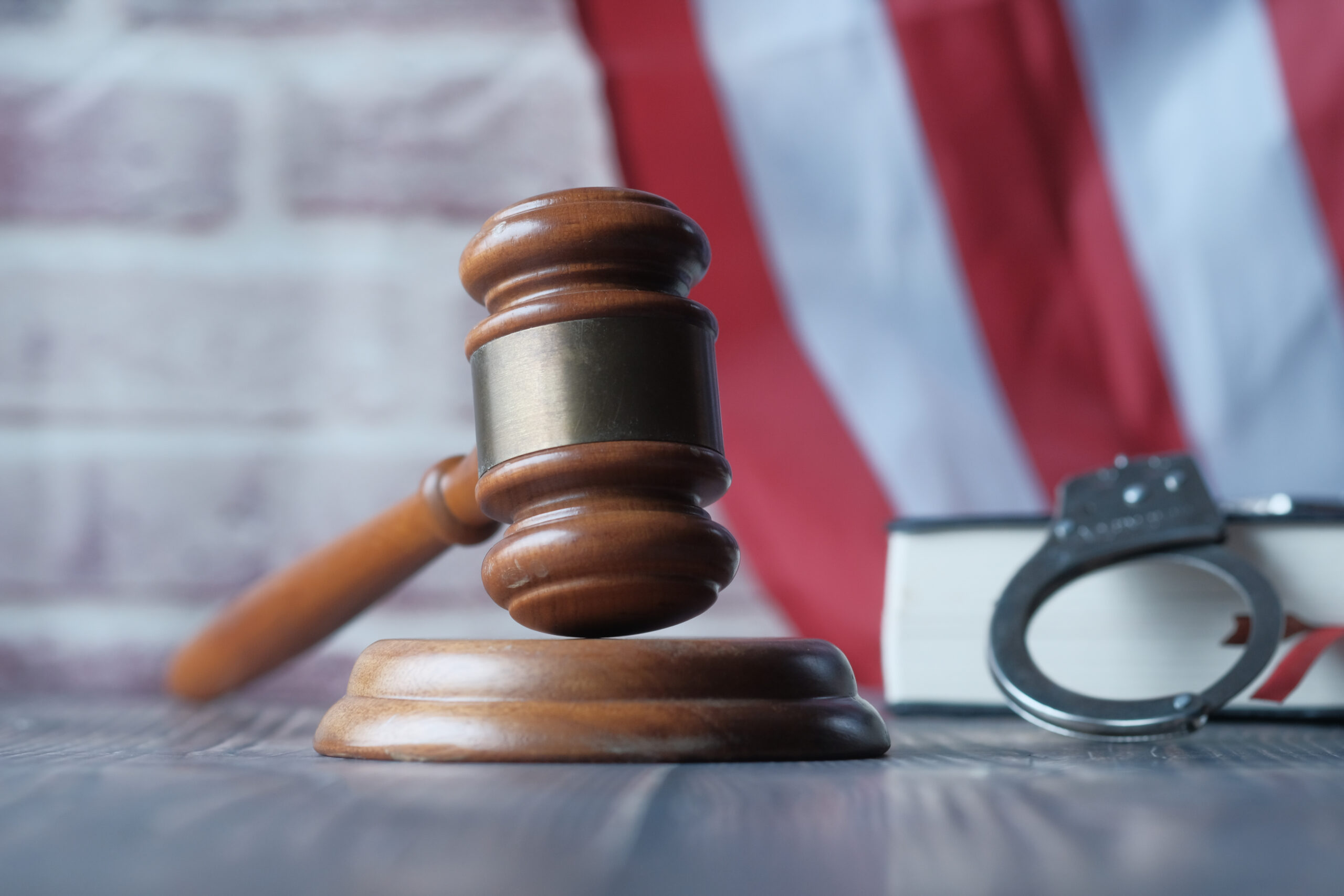 Justice and Law A Gavel, Handcuffs, and Legal Books Arranged Neatly on a Desk