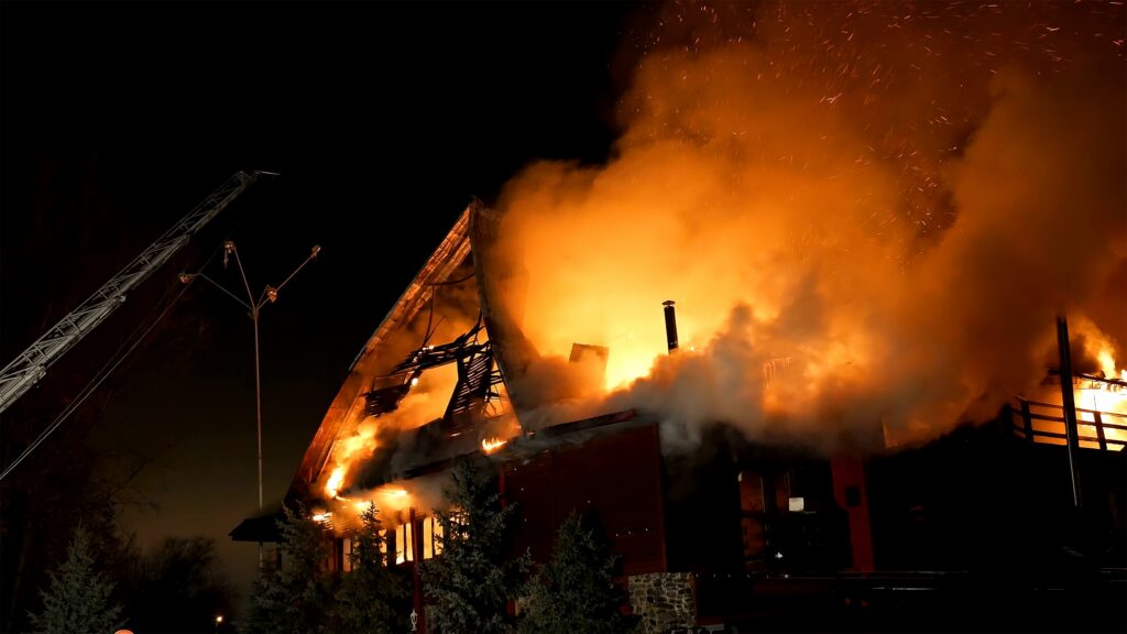 House building on fire at night. Blaze Inferno conflagration and combustion.